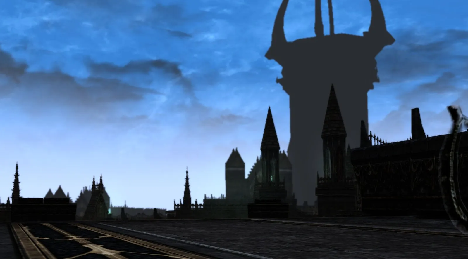 The towers of the Dark Fortress against the sky, seen from a terrace